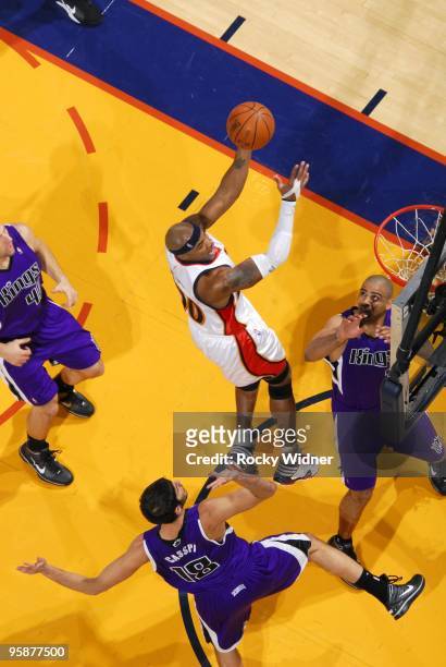 Corey Maggette of the Golden State Warriors goes up for a shot against Omri Casspi and Ime Udoka of the Sacramento Kings during the game at Oracle...