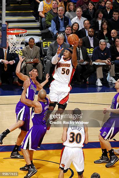 Corey Maggette of the Golden State Warriors goes up for a shot against Ime Udoka and Omri Casspi of the Sacramento Kings during the game at Oracle...