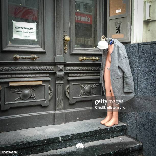 Deutschland Germany Berlin Eine halbe Schaufenster puppe steht, mit Lampe und Mantel dekoriert, in einem Eingang in der Joachimsthaler Strasse in...