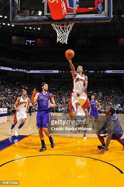 Monta Ellis of the Golden State Warriors shoots a layup against Omri Casspi and Tyreke Evans of the Sacramento Kings during the game at Oracle Arena...