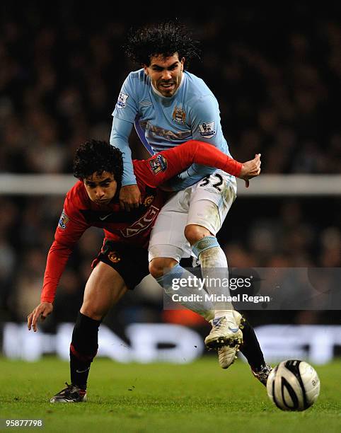 Carlos Tevez of Manchester City tangles with Rafael Da Silva of Manchester United during the Carling Cup Semi Final match between Manchester City and...