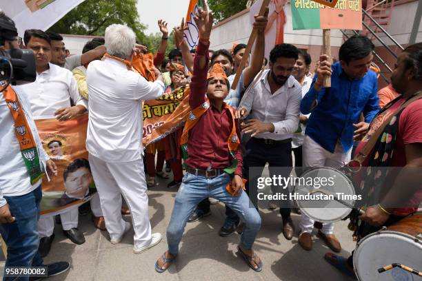 Bharatiya Janata Party activists and workers celebrate party's lead in the Karnataka elections outside party headquarters at Deendayal Upadhyay Marg,...