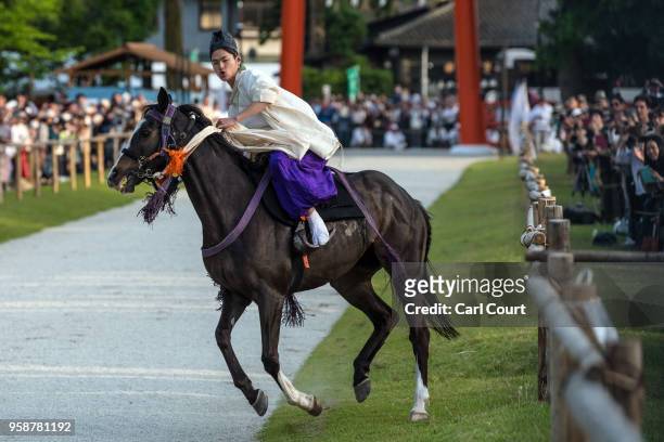 Participant rides a horse towards Kamigamo shrine during the Aoi Festival on May 15, 2018 in Kyoto, Japan. Aoi Festival is one of the three main...