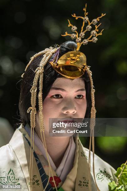 Woman in Heian period dress takes part in the the Aoi Festival on May 15, 2018 in Kyoto, Japan. Aoi Festival is one of the three main festivals of...