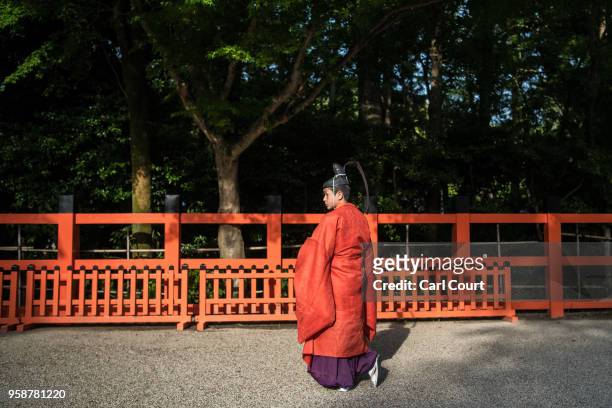 Participant waits in the grounds of Kamigamo shrine during the Aoi Festival on May 15, 2018 in Kyoto, Japan. Aoi Festival is one of the three main...