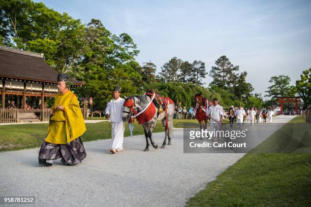 Participant leads horses into Kamigamo shrine during the Aoi Festival on May 15, 2018 in Kyoto, Japan. Aoi Festival is one of the three main...