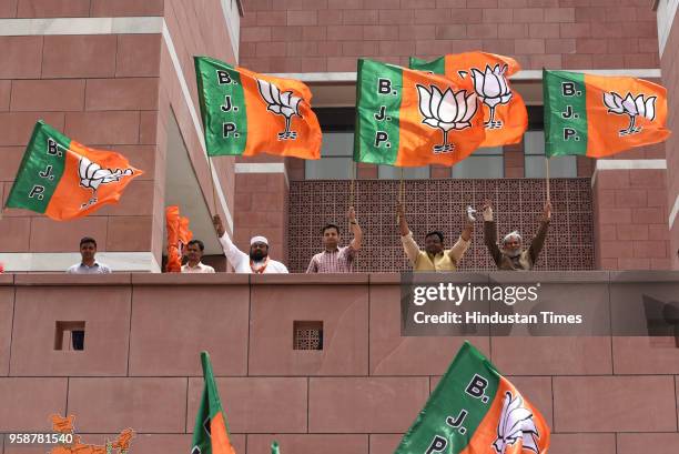 Bharatiya Janata Party activists and workers celebrate party's lead in Karnataka elections outside BJP headquarters, at Deen Dayal Upadhyay Marg, on...