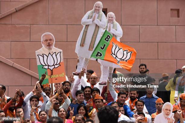 Bharatiya Janata Party activists and workers celebrate party's lead in Karnataka elections outside party headquarters, at Deen Dayal Upadhyay Marg,...