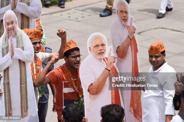 Bharatiya Janata Party activists and workers celebrate party's lead in Karnataka elections outside party headquarters, at Deen Dayal Upadhyay Marg,...