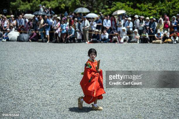Child in Heian period dress takes part in a parade through the grounds of Kyoto Imperial Palace during the Aoi Festival on May 15, 2018 in Kyoto,...