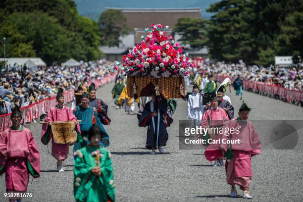 Participants in Heian period dress parade through the grounds of Kyoto Imperial Palace during the Aoi Festival on May 15, 2018 in Kyoto, Japan. Aoi...