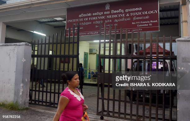 Sri Lankan resident walks past the Institute of Forensic Medicine and Toxicology in Colombo on May 15, 2018. - A second visiting English amateur...