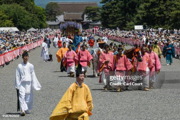 Participants in Heian period dress parade through the grounds of Kyoto Imperial Palace during the Aoi Festival on May 15, 2018 in Kyoto, Japan. Aoi...
