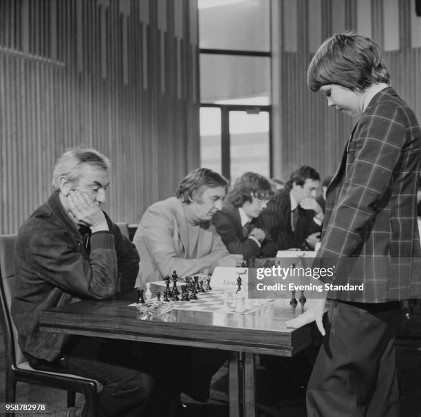 English chess grandmaster Nigel Short playing chess with English journalist Angus McGill at a tournament, UK, 21st February 1978.