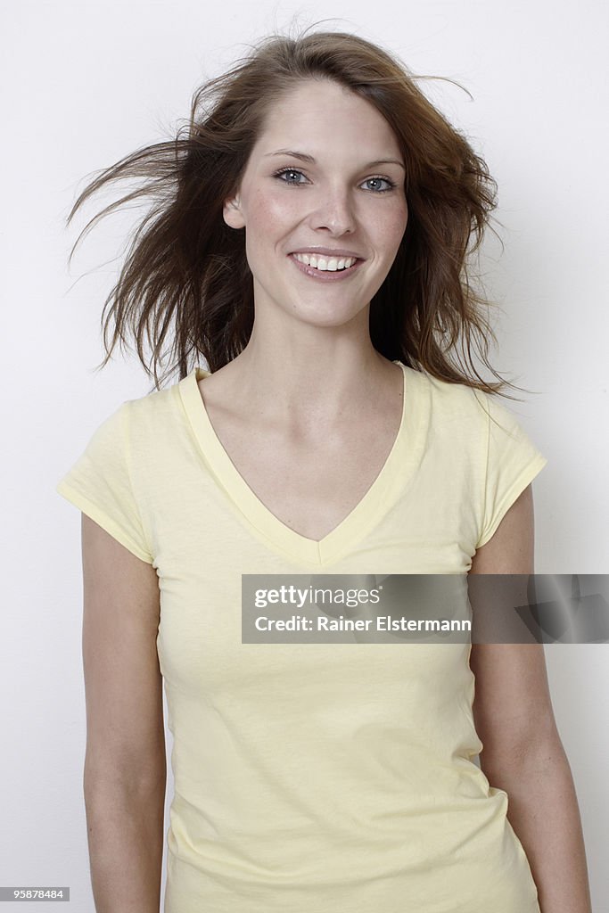 Portrait of woman smiling, hair blowing