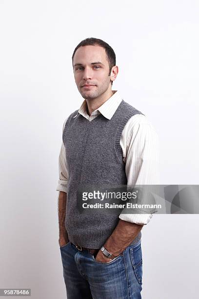 standing portrait of young man, studio shot - sweater vest photos et images de collection