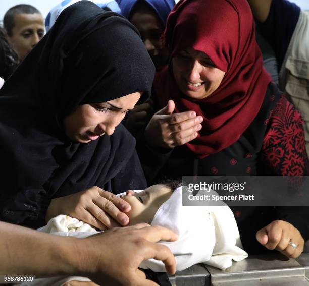 The mother of eight-month-old Leila Anwar Ghandoor, who died in the hospital on Tuesday morning from tear gas inhalation, looks at her daughter as...