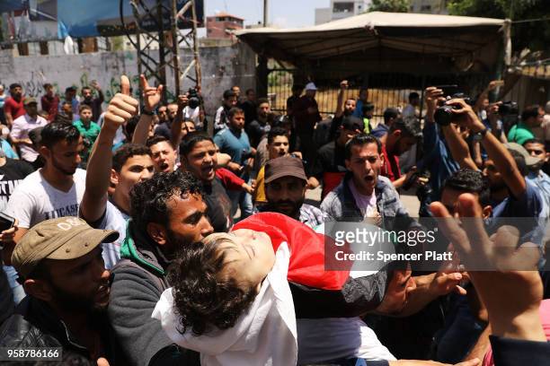 The father of eight-month-old Leila Anwar Ghandoor, who died in the hospital on Tuesday morning from tear gas inhalation, carries her to burial on...