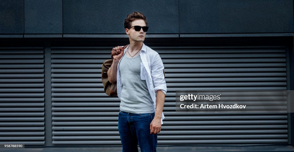Young tourist guy explores big city