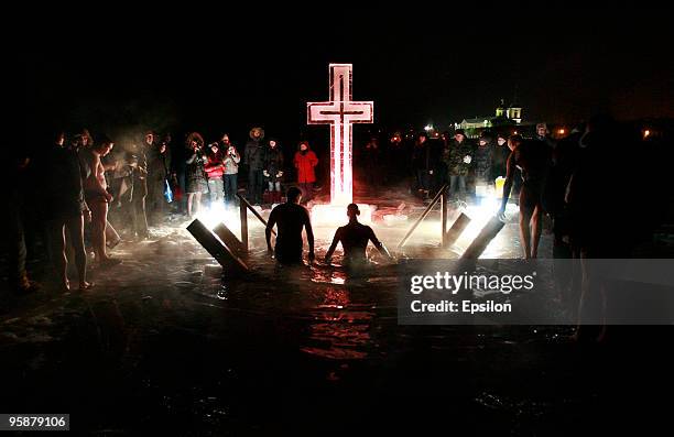 Russian Orthodox believers plunge in the icy waters of a Moscow pond in celebration of the Epiphany holiday early on January 19, 2010 in Moscow,...