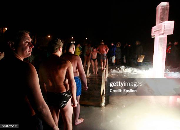 Russian Orthodox believers plunge in the icy waters of a Moscow pond in celebration of the Epiphany holiday early on January 19, 2010 in Moscow,...