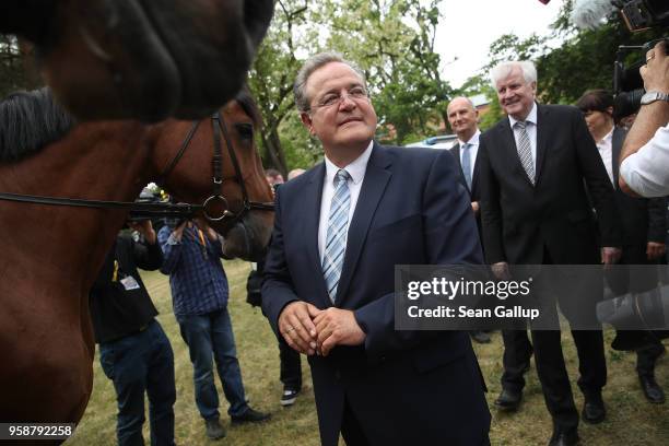 Dieter Romann , head of the German Federal Police and German Interior Minister Horst Seehofer prepare to chat with mounted police officers during a...