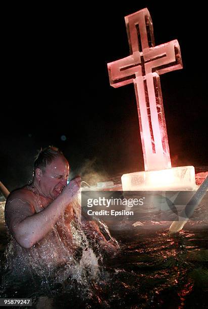 Russian Orthodox believers plunge in the icy waters of a Moscow pond in celebration of the Epiphany holiday early on January 19, 2010 in Moscow,...