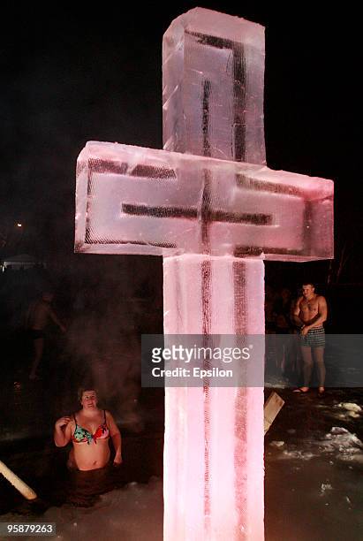 Russian Orthodox believers plunge in the icy waters of a Moscow pond in celebration of the Epiphany holiday early on January 19, 2010 in Moscow,...