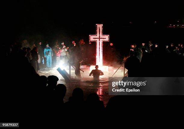 Russian Orthodox believers plunge in the icy waters of a Moscow pond in celebration of the Epiphany holiday early on January 19, 2010 in Moscow,...