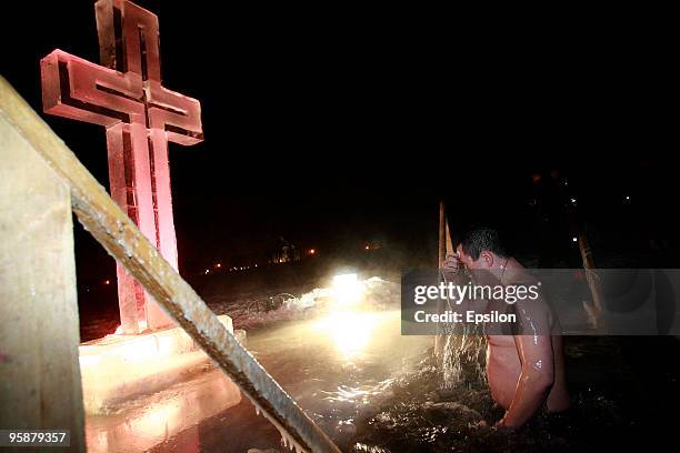 Russian Orthodox believers plunge in the icy waters of a Moscow pond in celebration of the Epiphany holiday early on January 19, 2010 in Moscow,...