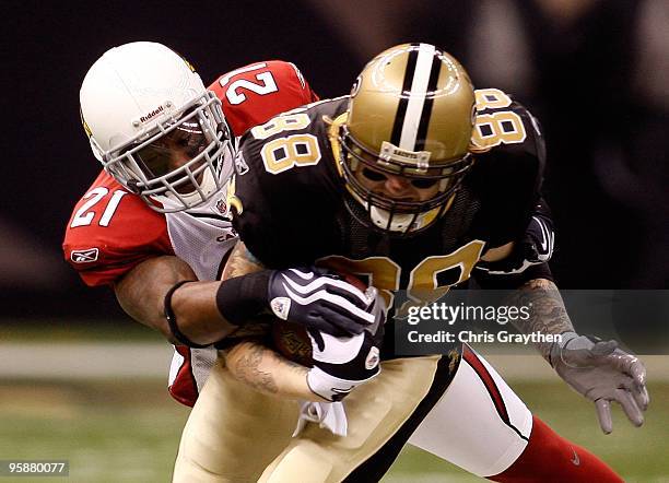 Antrel Rolle of the Arizona Cardinals attempts to tackle Jeremy Shockey of the New Orleans Saints during the NFC Divisional Playoff Game at Louisana...