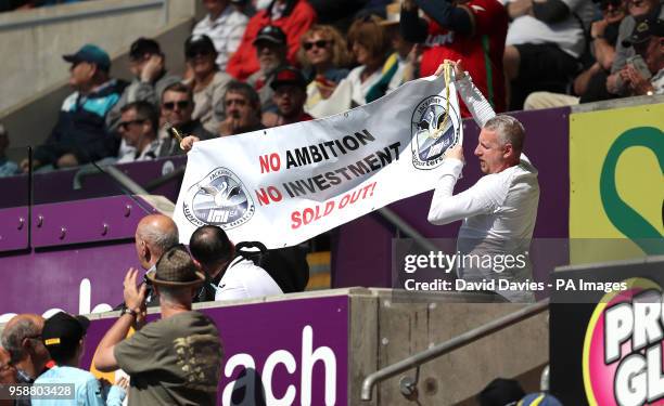 Swansea City supporters hold up a banner showing their dismay at the current state of the club during the Premier League match