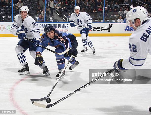 Chris Thorburn of the Atlanta Thrashers battles for the puck against Carl Gunnarsson and Francois Beauchemin of the Toronto Maple Leafs at Philips...