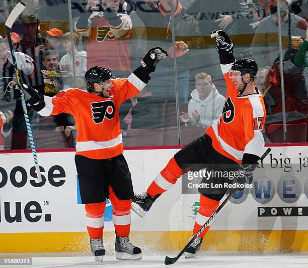 Kimmo Timonen and Jeff Carter of the Philadelphia Flyers celebrate Carter's goal against the Columbus Blue Jackets less than a minute into the game...