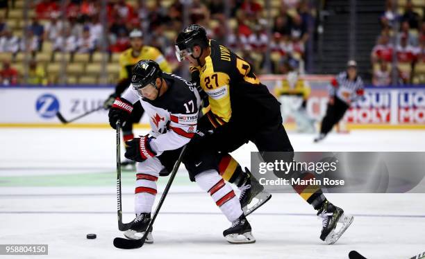 Jaden Schwartz of Canada and Sebastian Uvira of Germany battle for the puck during the 2018 IIHF Ice Hockey World Championship Group B game between...