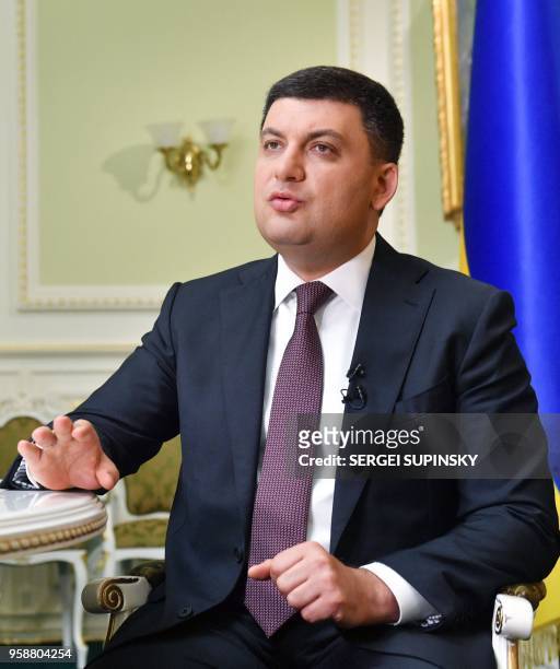 Ukrainian Prime Minister Volodymyr Groysman speaks to a journalist during his interview for AFP in his office in Kiev on May 15, 2018. Ukrainian...