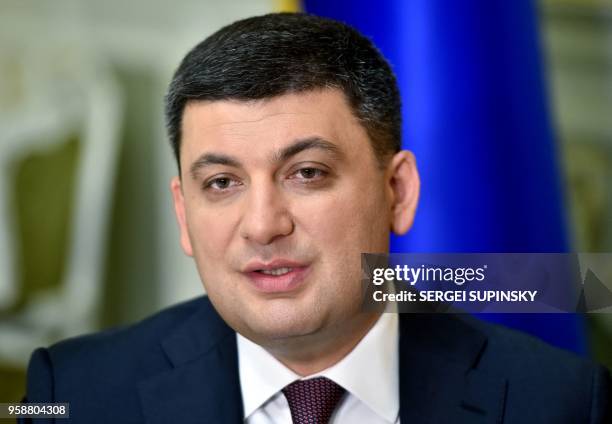 Ukrainian Prime Minister Volodymyr Groysman speaks to a journalist during his interview for AFP in his office in Kiev on May 15, 2018. - Ukrainian...