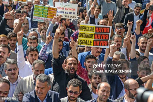 Protesters chant slogans as they hold a placard reading "No to Imperialism, No to Zionism, No to Occupation" in Diyarbakir on May 15, 2018 during a...