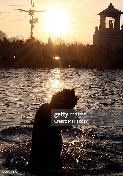 Devotees take the holy dip in the Ganges on the auspicious occasion of Mauni Amavasya during the ongoing Maha Kumbh in Haridwar on Friday, January...