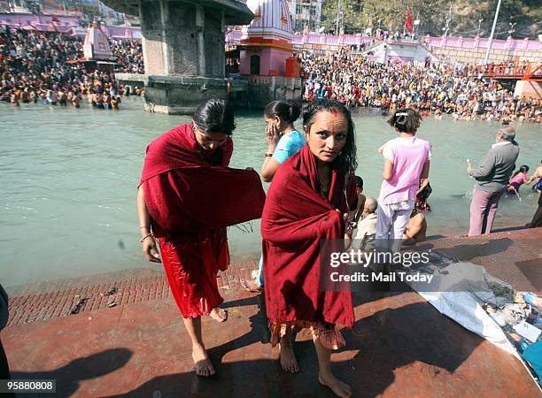 Devotees take the holy dip in the Ganges on the auspicious occasion of Mauni Amavasya during the ongoing Maha Kumbh in Haridwar on Friday, January...