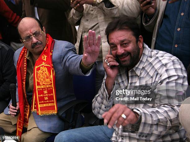 Senior Samajwadi Party Leader Amar Singh gestures as he addresses a press conference as Indian Actor Sanjay Dutt looks on during a press conference...