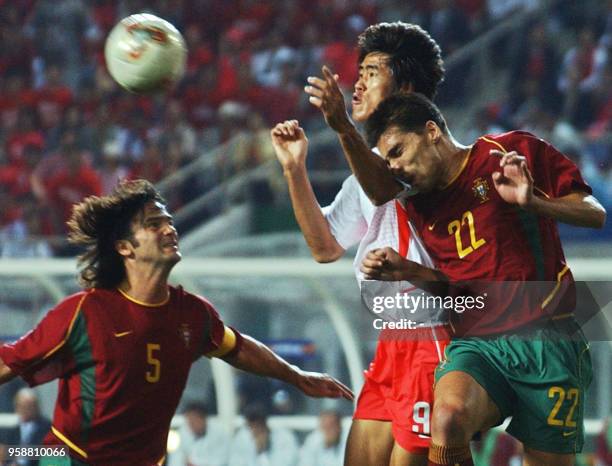 Portugal's Beto beats Korea's Seol Ki Hyeon to the ball as Fernando Couto watches,14 June 2002 at the Incheon Munhak Stadium in Incheon, during first...