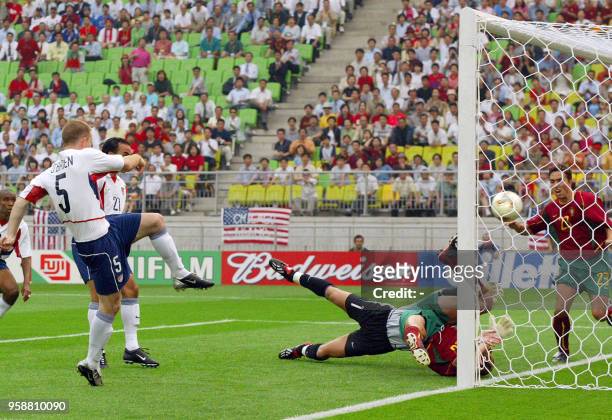 Midfielder John O'Brien scores the first goal of the USA-Portugal Group D match as Portugal's goalkeeper Vitor Baia , midfielder Petit and defender...