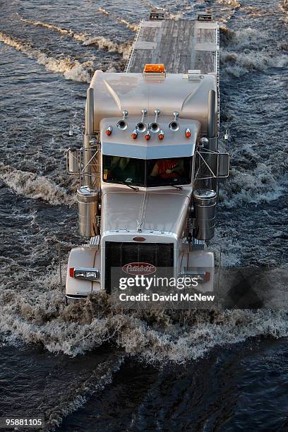 Truck moves through flood waters in southbound lanes of the 710 freeway as the freeway is shut down during the evening rush hour after the second...