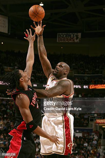 Shaquille O'Neal of the Cleveland Cavaliers shoots over Chris Bosh of the Toronto Raptors on the night he becomes the fifth ever NBA player to score...