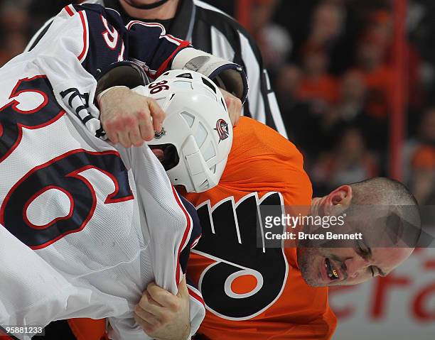 Mathieu Roy of the Columbus Blue Jackets and Ian Laperriere of the Philadelphia Flyers fight during the second period at the Wachovia Center on...