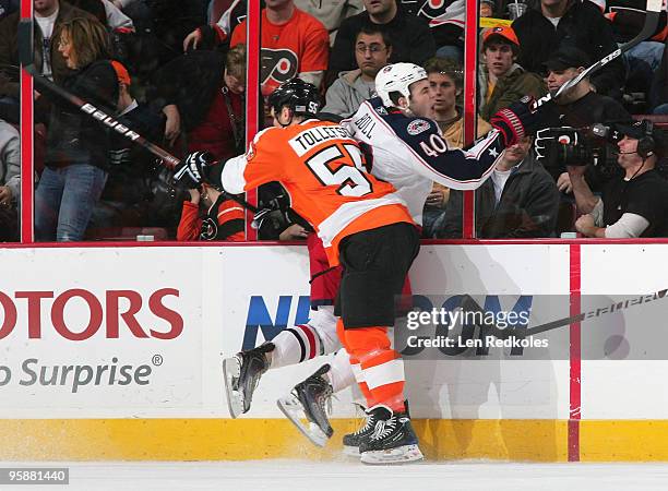 Ole-Kristian Tollefsen of the Philadelphia Flyers checks Jared Boll of the Columbus Blue Jackets into the boards on January 19, 2010 at the Wachovia...