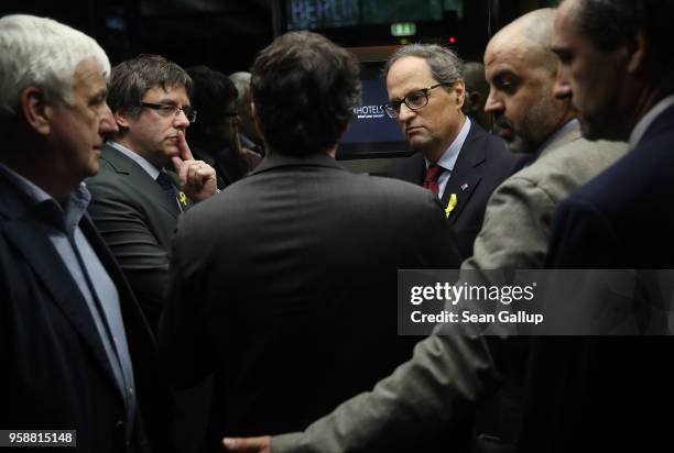 Former Catalan separitist leader Carles Puigdemont and newly-elected Catalan leader Quim Torra enter an elevator after speaking to the media at a...
