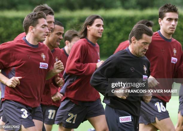 Portugese forward Nuno Gomes runs with his teammates Rui Jorge, Manuel Dimas, Costinha and Beto during practice 26 June 2000 at the Sportpark in...