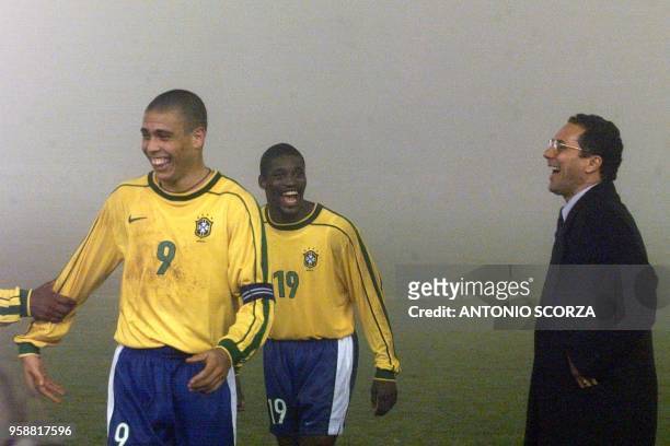 Brazilian Technical Director Wanderley Luxemburgo greets Ronaldo and Beto after referee Horacio Elizondo decided to halt their Copa America group B...